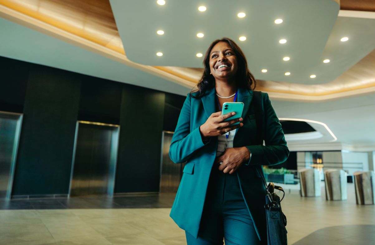Employee exploring a workplace with a smartphone during onboarding